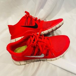 Kid’s size 6 (women’s 8) red bedazzled Nike Free Runs.